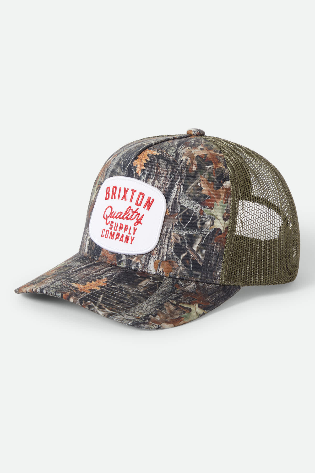 Unisex Hubal Netplus Trucker Hat in the color Tree Camo/Olive - Front Product Laydown Image