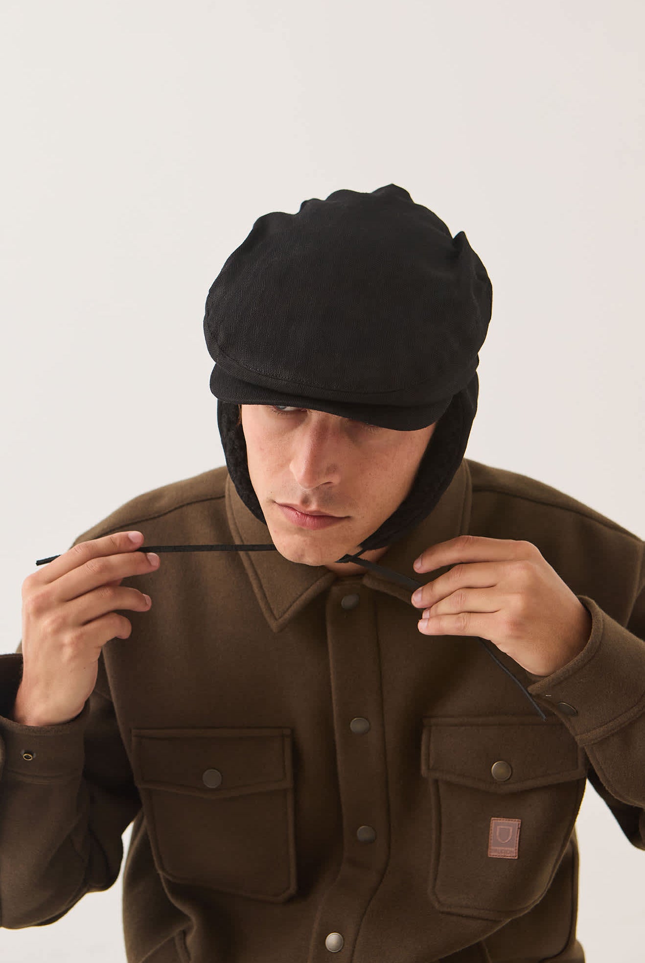 Unisex Barrel Earflap Snap Cap in the color Black/Black - Additional Fit image