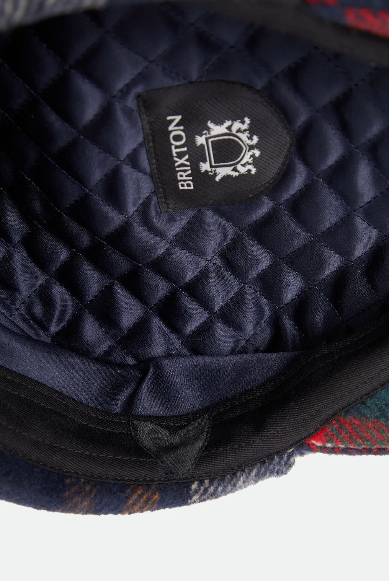 Unisex Barrel Earflap Snap Cap in the color Navy/Green/Red/Cream - Additional Laydown image