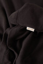 Women's Carefree Organic Garment Dye Cropped Henley in the color Black - Additional Laydown image