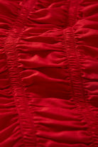 Women's Eden Smocked Top in the color Crimson - Additional Laydown image