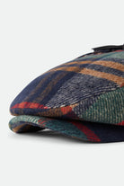 Unisex Barrel Earflap Snap Cap in the color Navy/Green/Red/Cream - Additional Laydown image