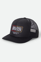 Unisex Caldwell Netplus Trucker Hat in the color Black/Black - Front Product Laydown Image