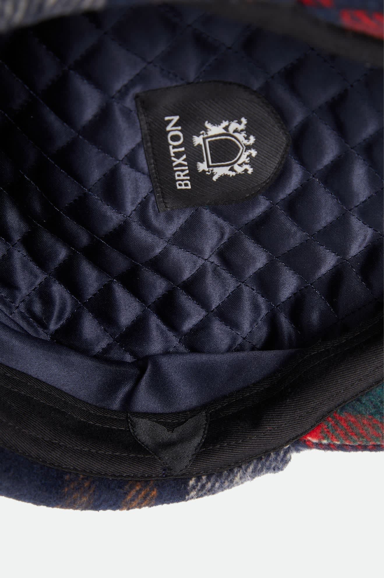 Unisex Barrel Earflap Snap Cap in the color Navy/Green/Red/Cream - Additional Laydown image